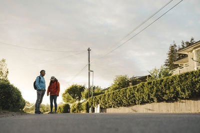 Couple of hikers standing on road
