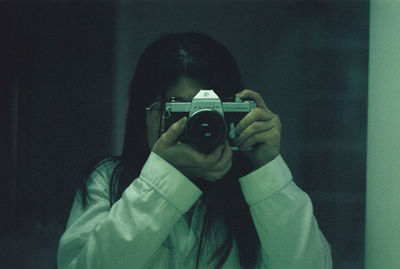 Portrait of man photographing camera