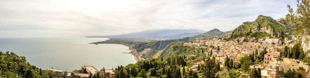 Panoramic view of sea and buildings against sky