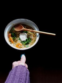 Close-up of person holding meal in bowl