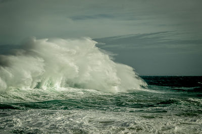 Scenic view of sea waves against sky