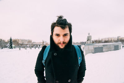 Portrait of man standing in snow