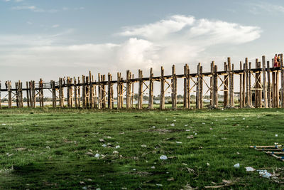 Fence on field against sky