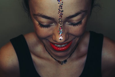 Close-up of smiling woman wearing make-up