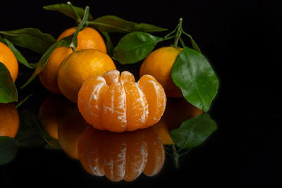 Close-up of orange fruit against black background