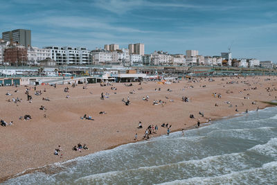 High angle view of people at beach against buildings