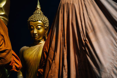 Statue of buddha against building