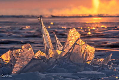 Close-up of frozen sea during winter against sky