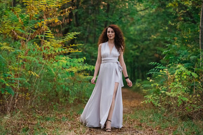 Portrait of woman standing in forest