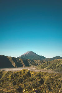 Scenic view of mountains against clear blue sky