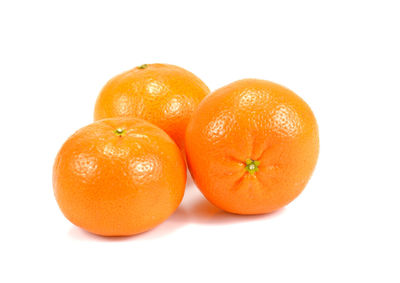 Close-up of orange fruit against white background