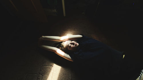 High angle view of woman lying on floor