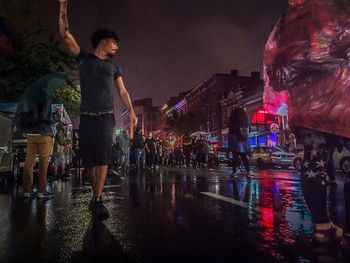 Illuminated wet city during rainy season at night
