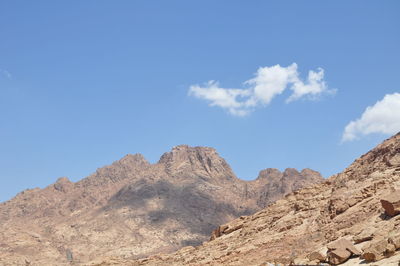 Low angle view of mountains against clear blue sky