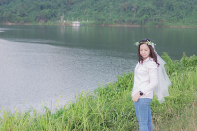 Portrait of smiling woman standing in water