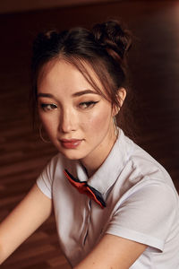 Asian high school student sitting at the piano