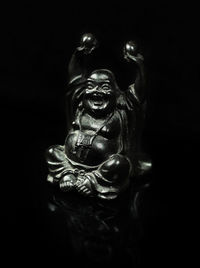 Close-up of statue against black background