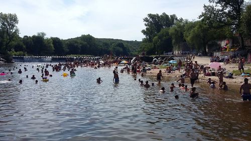 People enjoying in park against sky