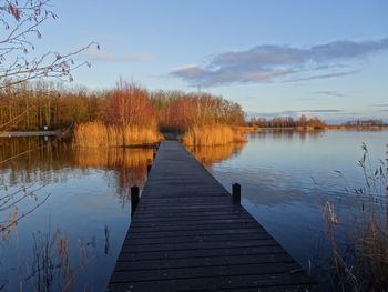 Pier over lake against sky