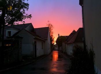 Houses against sky at sunset
