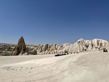 Scenic view of desert against clear blue sky