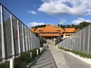 Bridge amidst buildings against sky in city