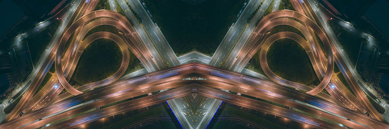 Low angle view of illuminated metallic structure against sky at night
