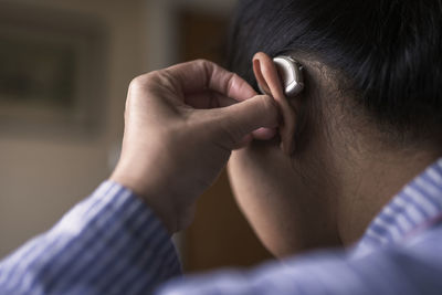 Close-up of woman with hearing aid