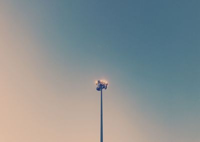 Low angle view of illuminated lights against clear sky at night