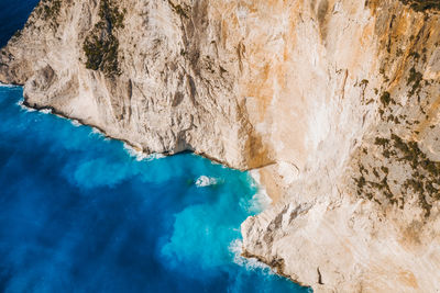 Aerial view of limestone cliffs of navagio or shipwreck beach on zakynthos island, greece.