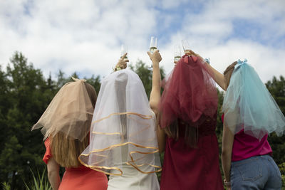 Rear view of woman standing against sky