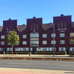 View of residential buildings against clear blue sky