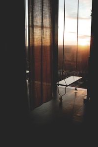 Empty chairs and table against window at home