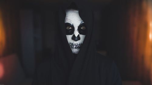 Portrait of person wearing ghost make-up at home during halloween