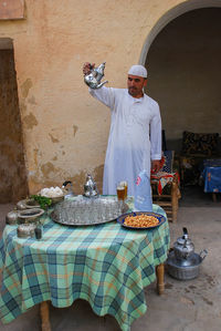 Portrait of man working on barbecue grill