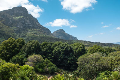 Scenic view of green mountains against sky