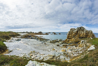 Rocks on shore against sky