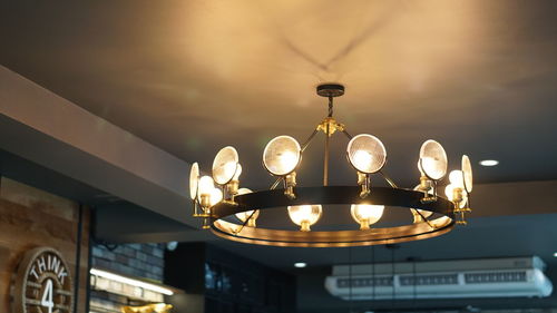 Low angle view of illuminated light bulb against sky