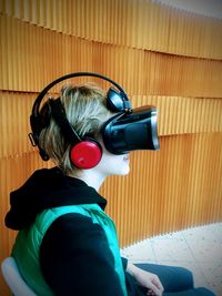 Rear view of man using mobile phone