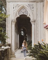 Rear view of woman standing in historic building