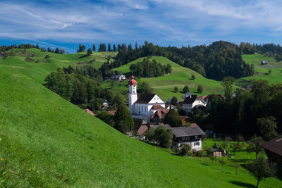 Houses on field against sky