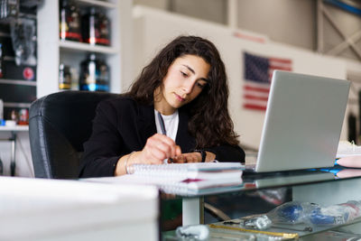 Businesswoman using laptop at office