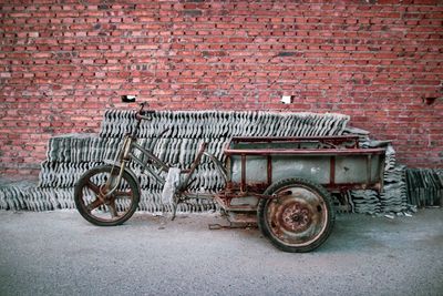 Vintage bicycle parked against brick wall