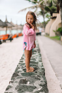 Full length of cute girl standing on street