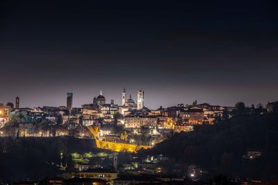 High angle view of illuminated buildings in city at night