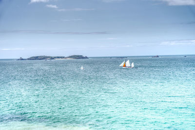 Sailboat in sea against sky