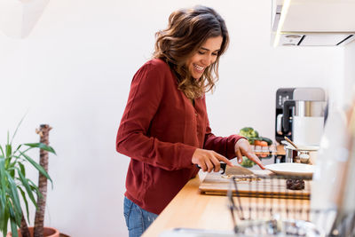 Woman standing on table at home