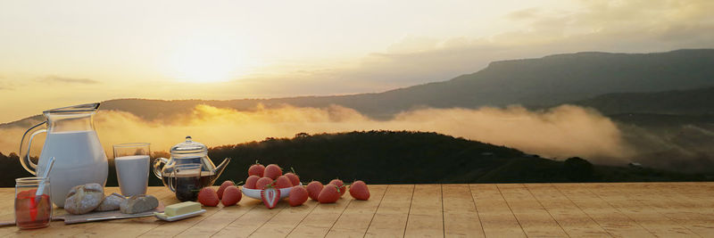 Panoramic shot of food on table against sky during sunset