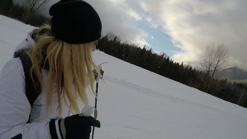 Rear view of man on snow covered landscape