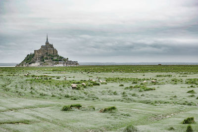 Temple by building against sky
